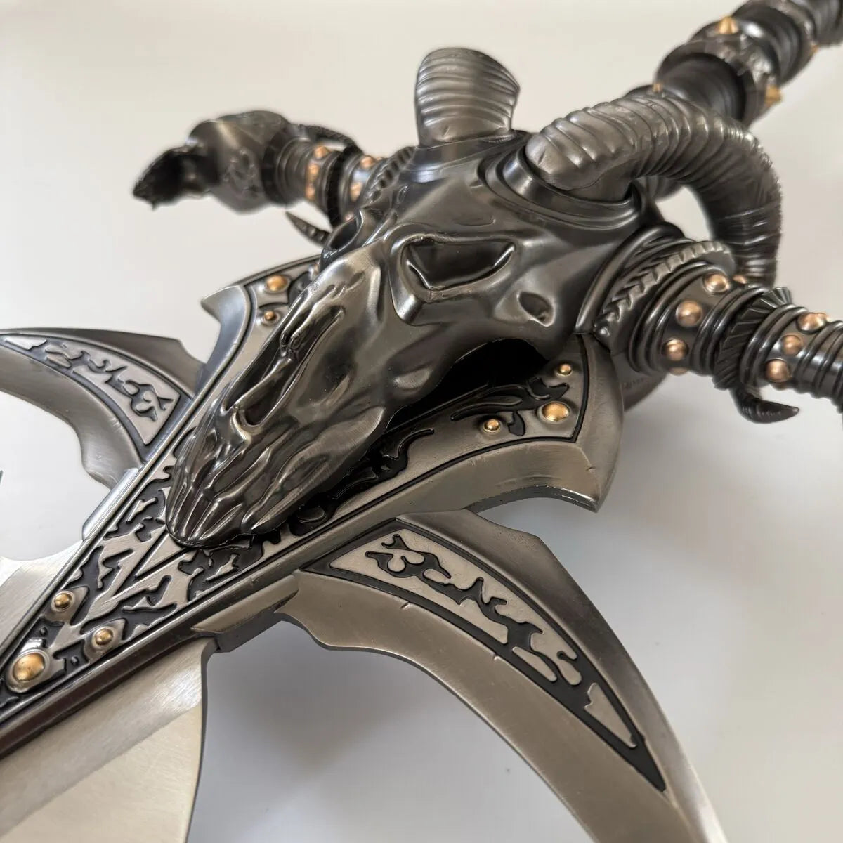 Decorative weapon with intricate designs on a white background