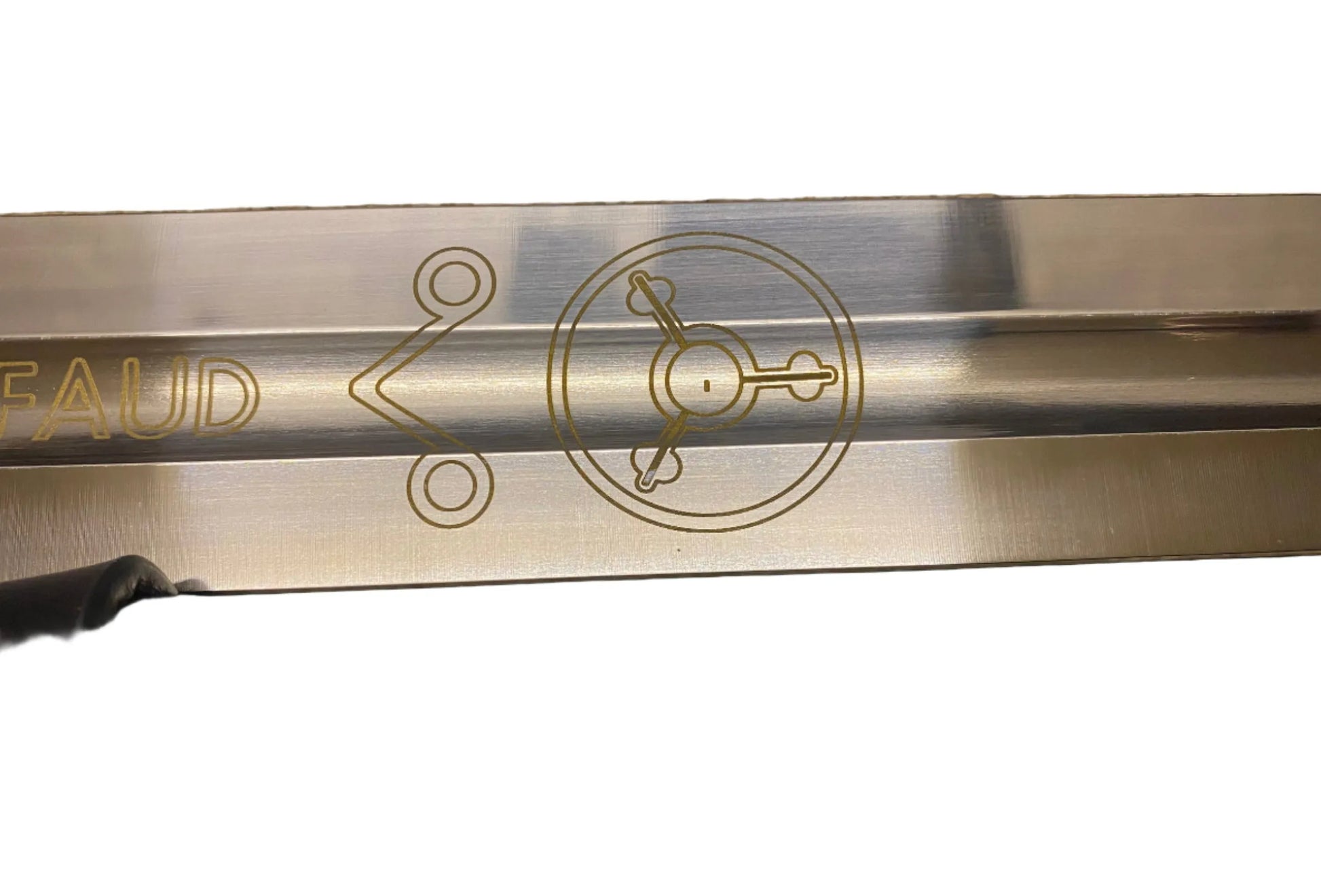 Metal blade with engraved design and 'FAUD' branding on a white background