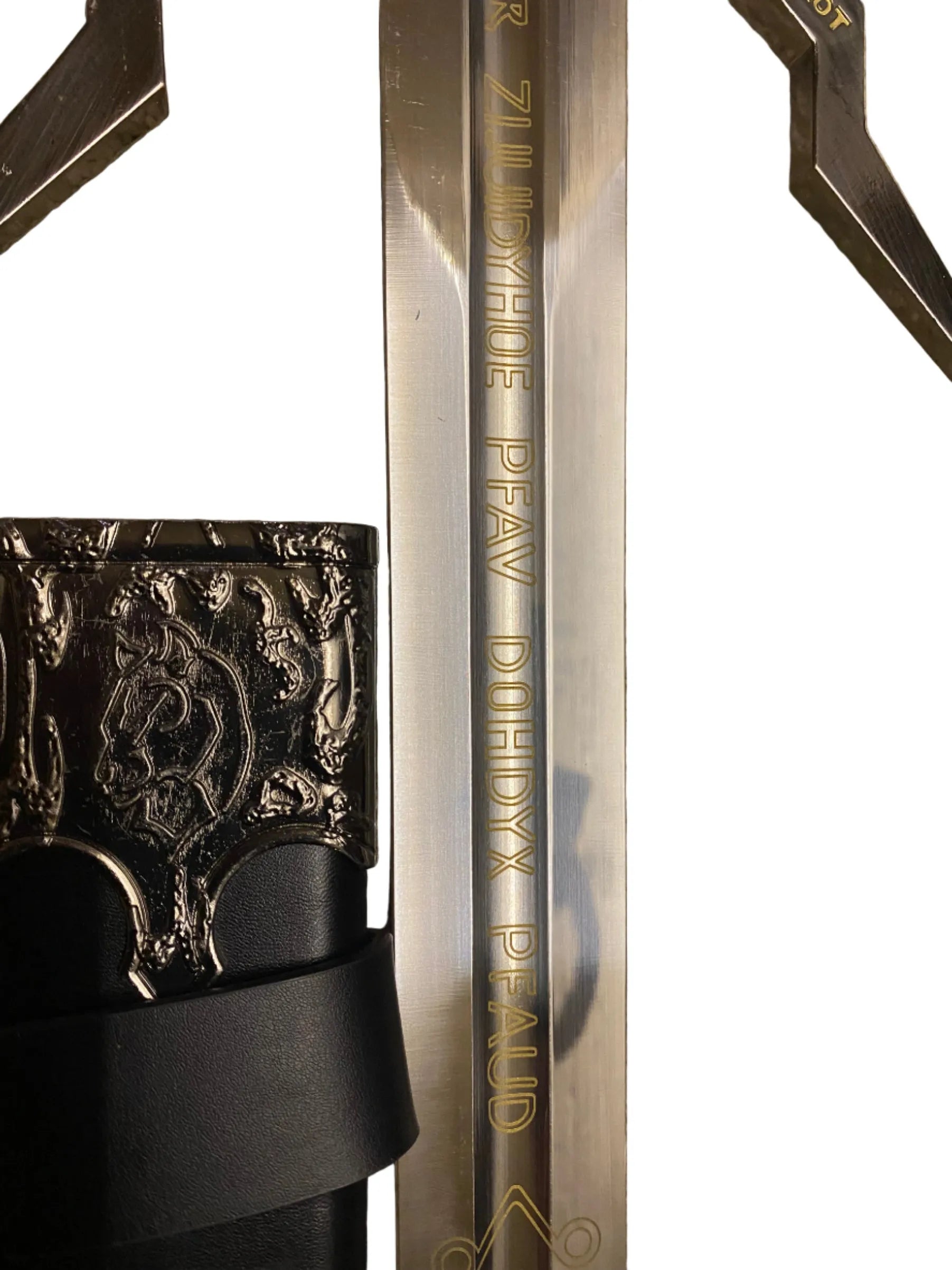 Close-up of a sword with engraved text on a white background