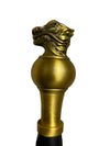 Decorative gold finial on a textured surface