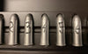 Set of six metallic bullets with engraved numbers on a dark background