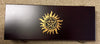 Black box with gold symbol on a beige carpet