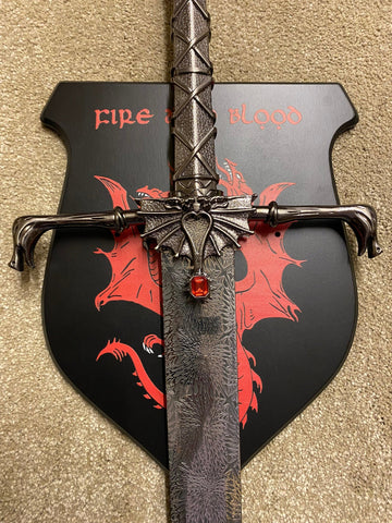 Decorative axe with dragon design and 'Fire' text on a beige background