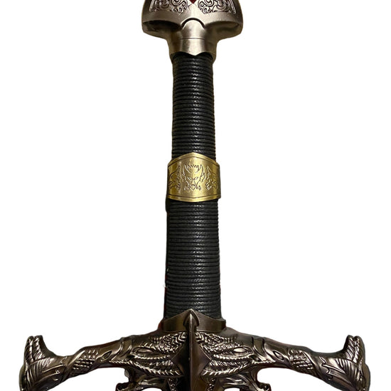 Decorative sword with a detailed hilt and red gem on a white background