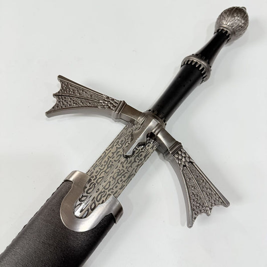 Decorative sword with intricate metalwork on a white background