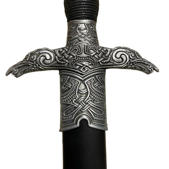 Decorative sword handle with intricate metalwork on a white background