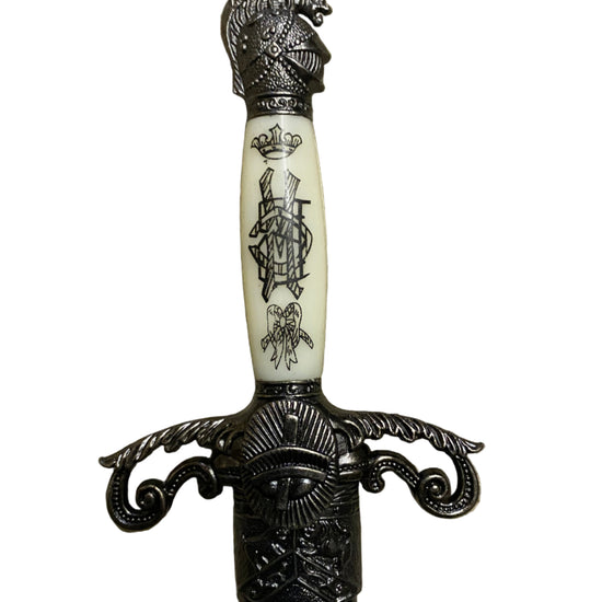 Decorative dagger with ornate handle on a white background