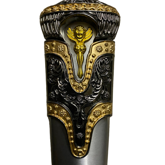 Decorative handle of a sword with intricate gold and silver design on a white background