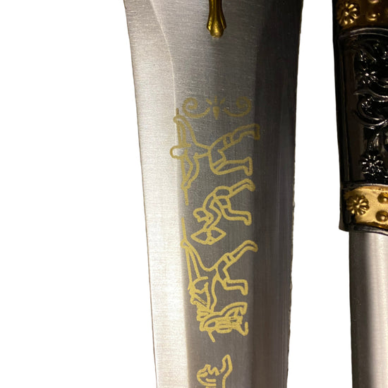 Decorative dagger with gold engravings on a white background