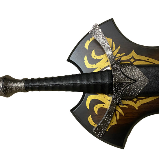 Decorative sword with a detailed handle and gold patterns on a white background
