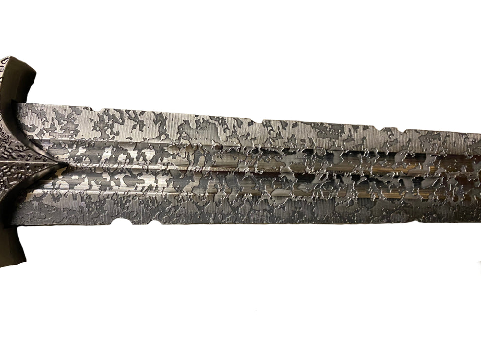 Decorative sword with intricate patterns on a white background