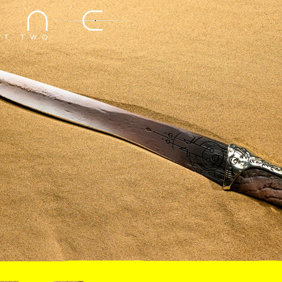 Decorative sword with intricate handle on a sand-like background, featuring 'Dune Part Two' text.