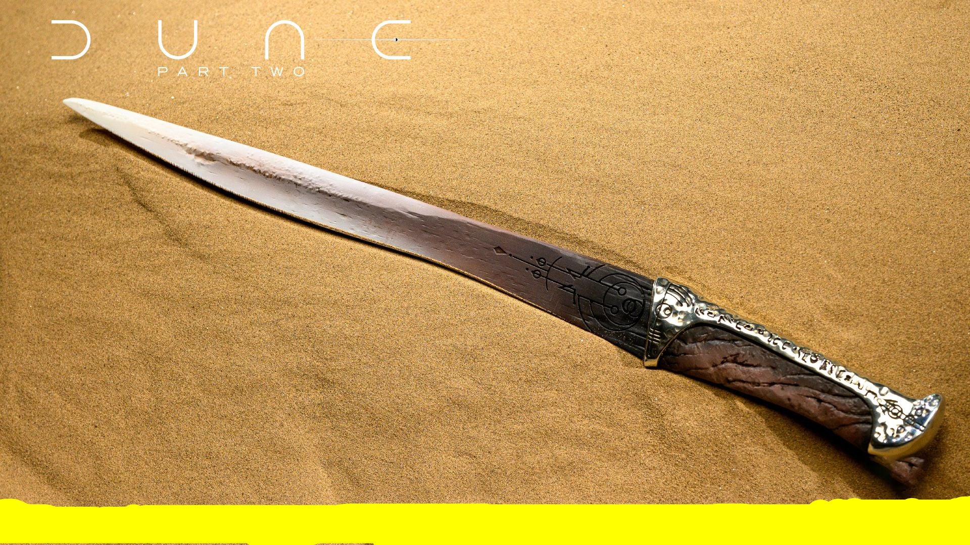Decorative sword with intricate handle on a sand-like background, featuring 'Dune Part Two' text.