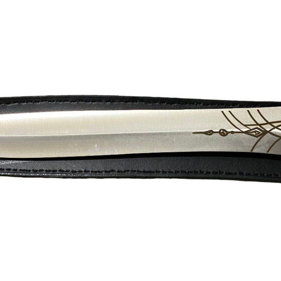 Decorative dagger with intricate handle design on a white background