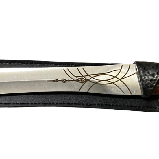 Decorative dagger with a detailed blade on a white background