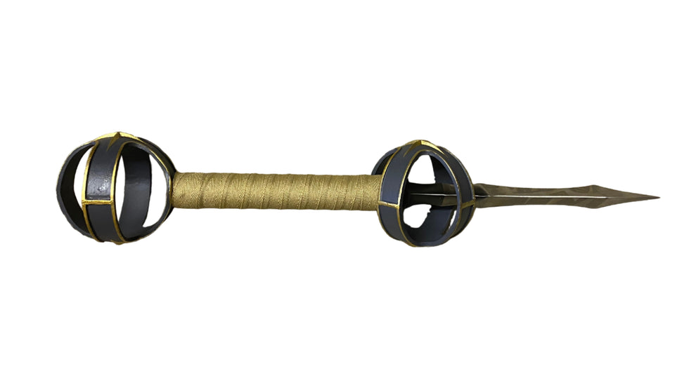 Decorative spear with black and gold design on a white background