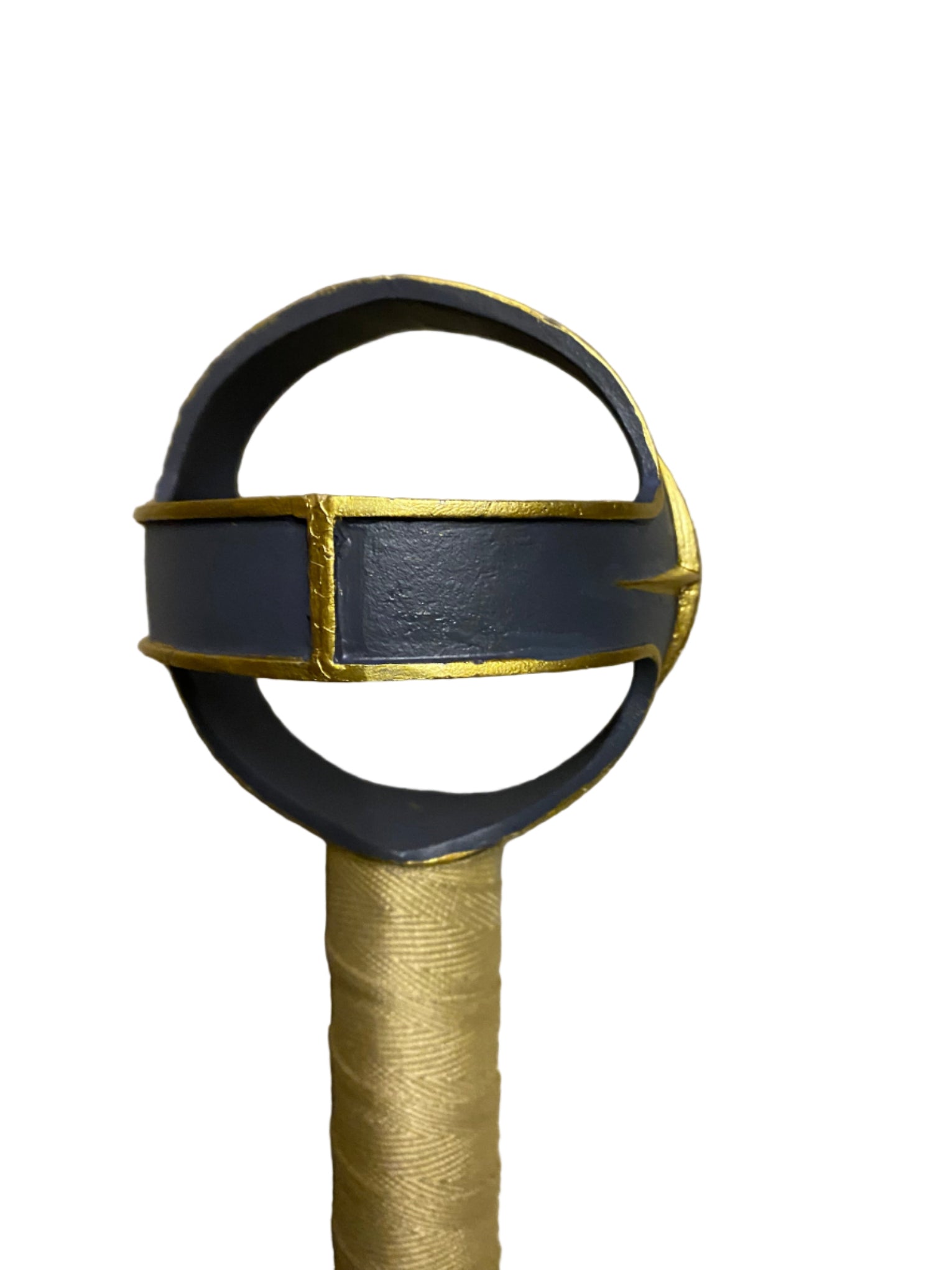 Sword hilt with black and gold design on a white background