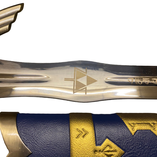 Close-up of a sword with gold and blue design on a white background