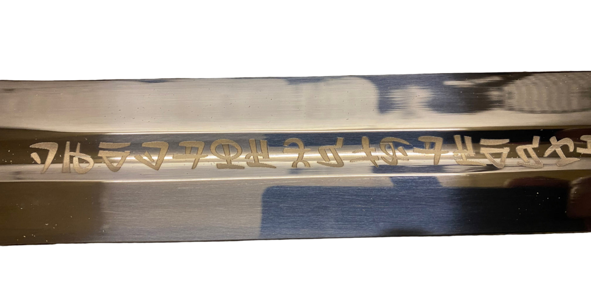 Sword blade with engraved text on a white background