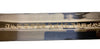 Sword blade with engraved text on a white background