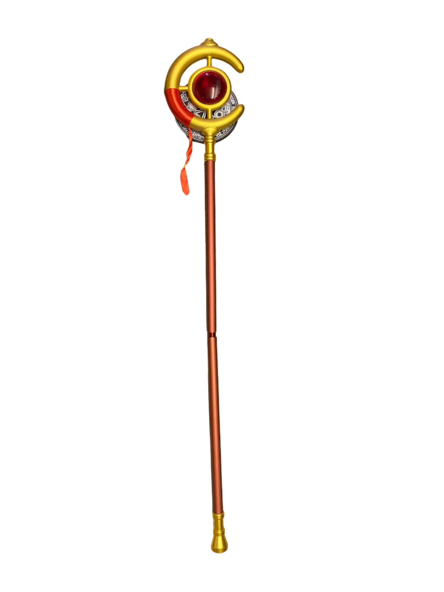 Decorative staff with a red gem and gold accents on a counter.