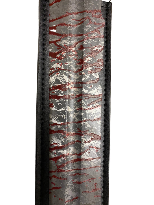 Decorative item with red and white pattern on a gray background