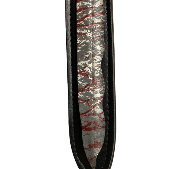 Close-up of a sword with a unique pattern on a white background