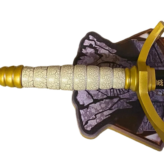 Decorative sword with gold nock and purple and brown patterned plaque on a white background