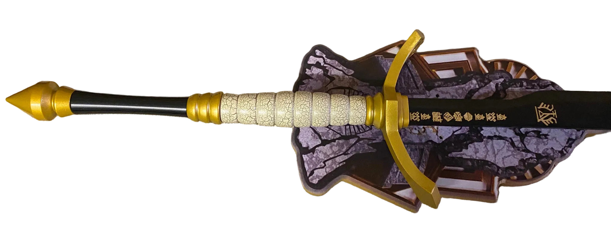 Decorative sword with gold nock and purple and brown patterned plaque on a white background