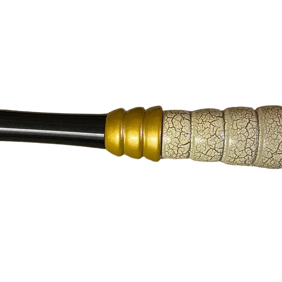 Decorative sword with gold and black accents on a white background