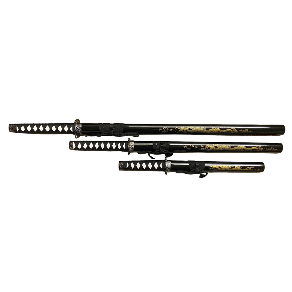 Set of three black and gold samurai swords with sheaths on a white background