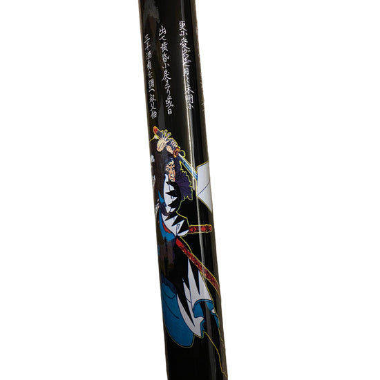 Black sword handle with artistic design and text on a white background