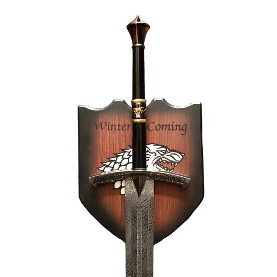 Decorative sword with 'Winter is Coming' and a wolf emblem on a white background