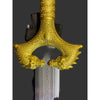 Decorative gold hilt of a sword on a dark background