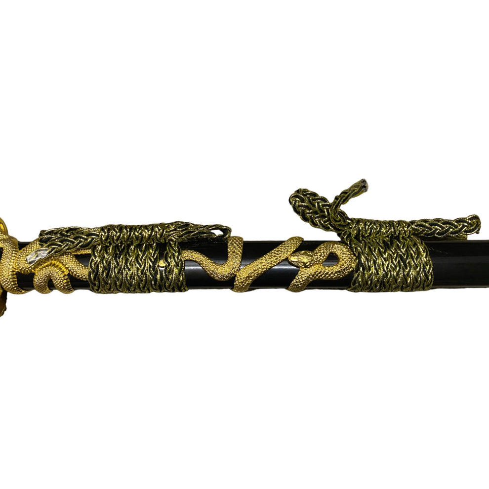 Decorative sword with gold and black design on a white background