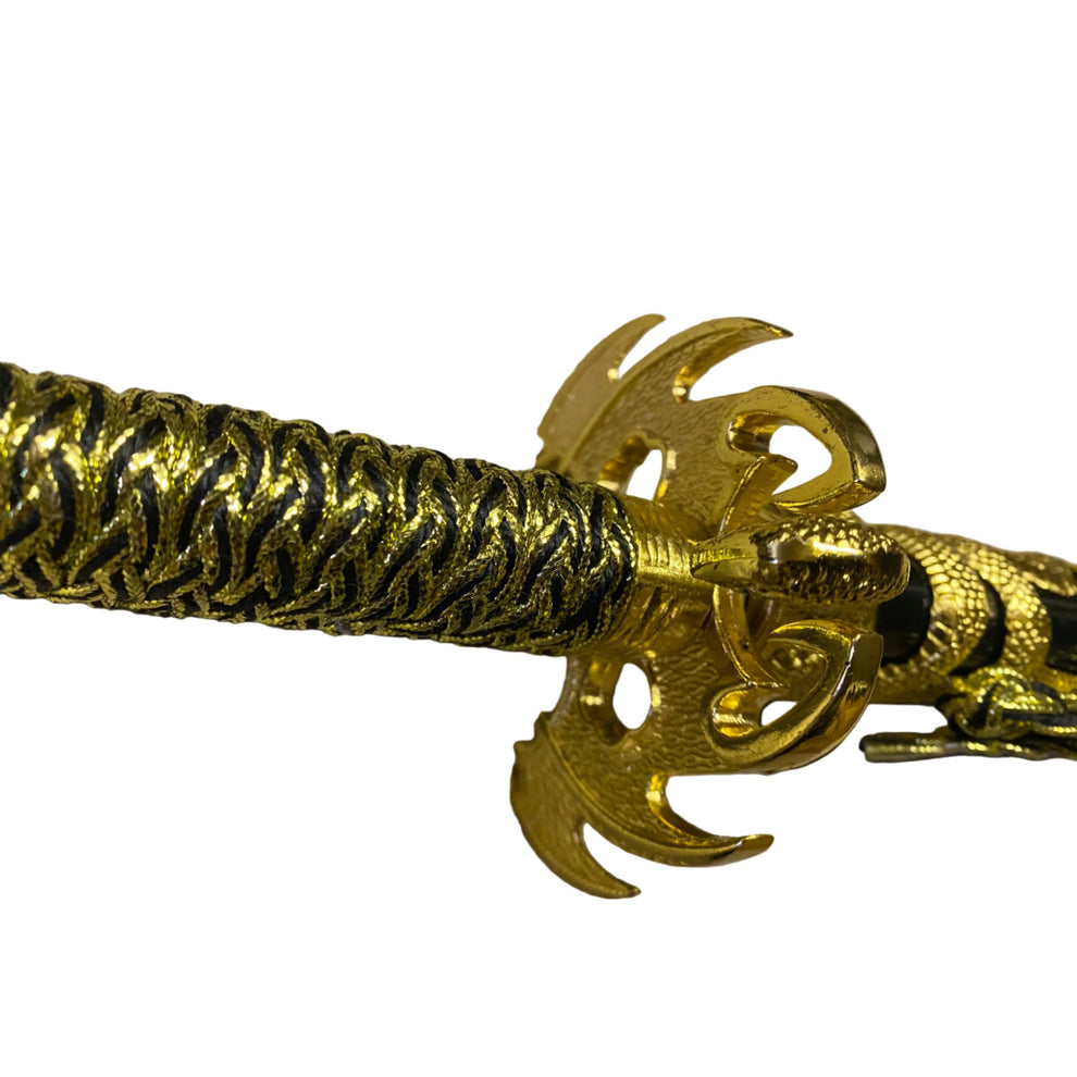 Gold bracelet with intricate design on a beige background