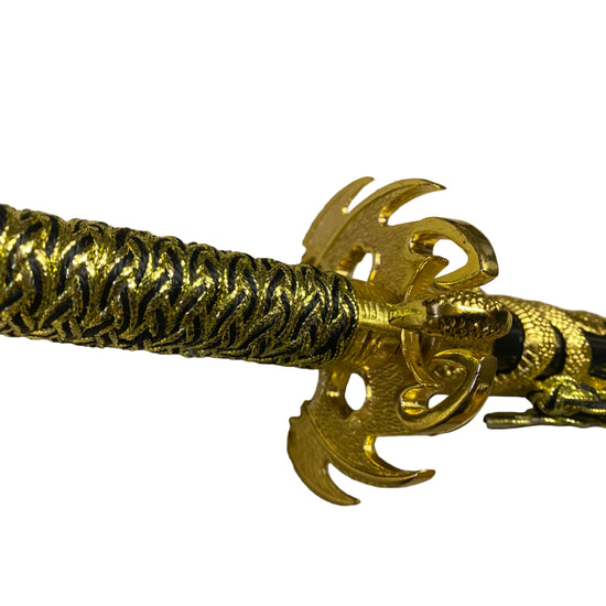 Gold bracelet with intricate design on a beige background