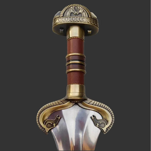 Decorative sword hilt with intricate designs on a white background
