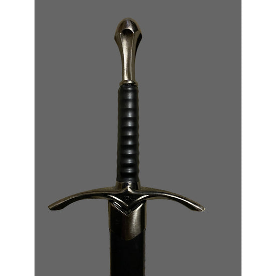 Sword with a black handle and silver blade on a gray background