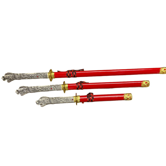 Three red swords with silver and gold handles on a white background