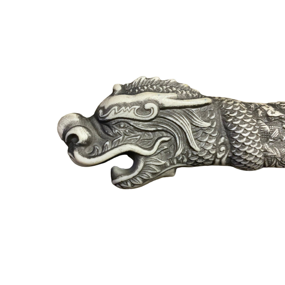 Decorative dragon head sculpture on a white background