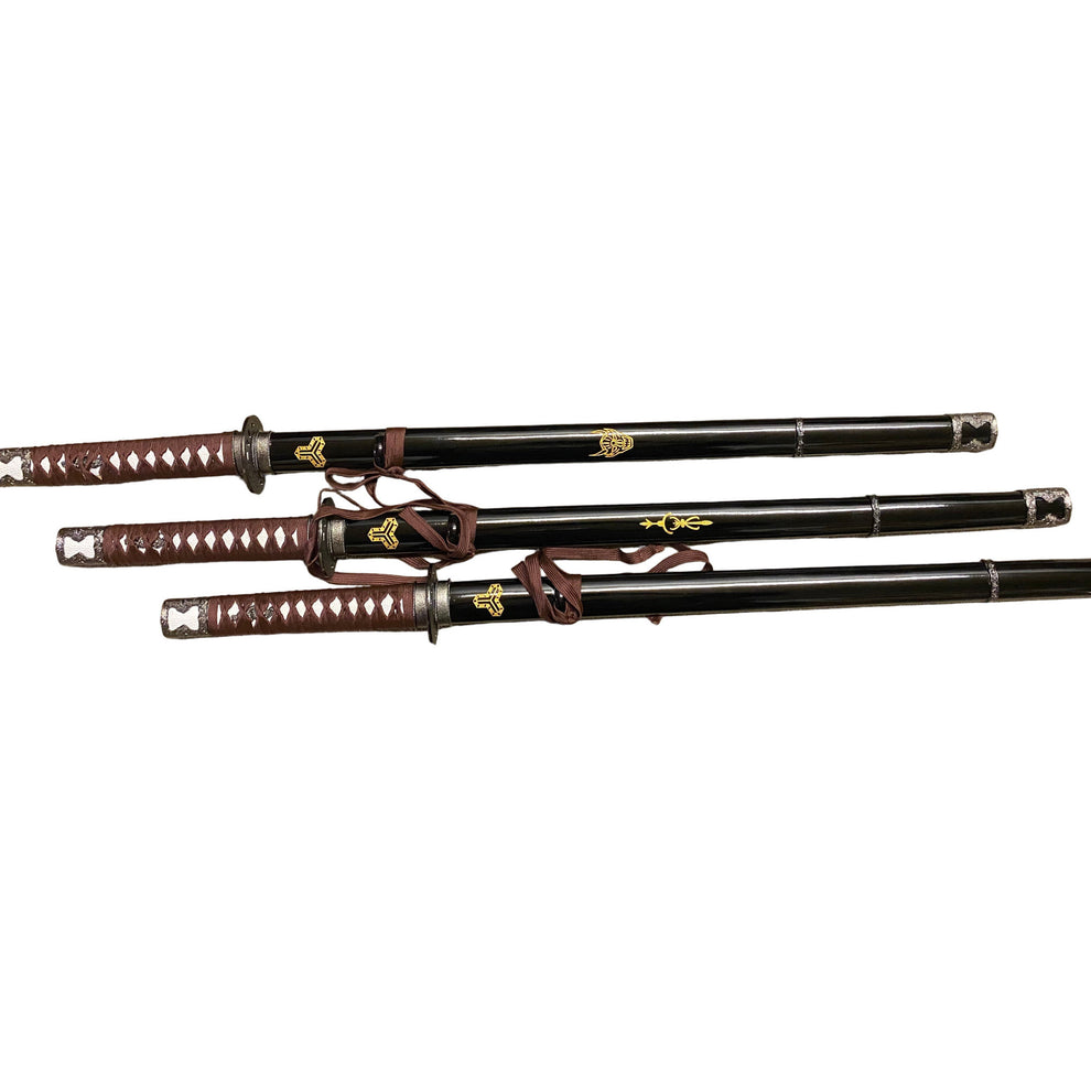 Three black samurai swords with brown sheaths on a white background