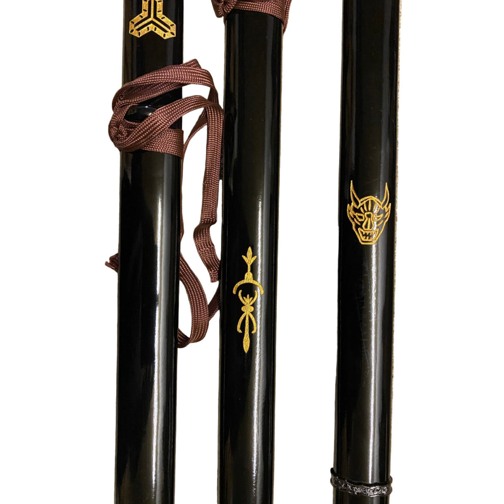 Three black swords with gold symbols on a white background