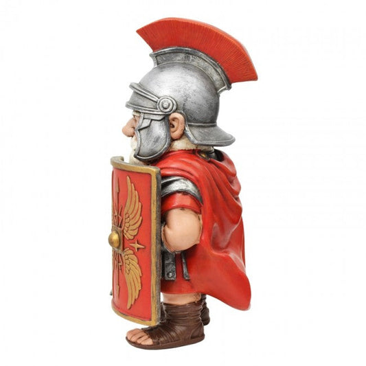 A Roman soldier figurine shown in profile, wearing a silver helmet with a red crest, a red cape, and holding a red shield with a gold eagle emblem. The figurine is set against a plain white background with a small 'The Knight Shop' logo in the bottom right corner.