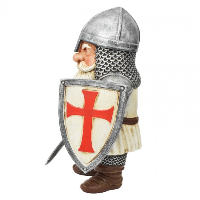 A medieval knight garden gnome figurine wearing silver chainmail armor and a silver helmet, holding a silver shield with a red cross on a cream background.