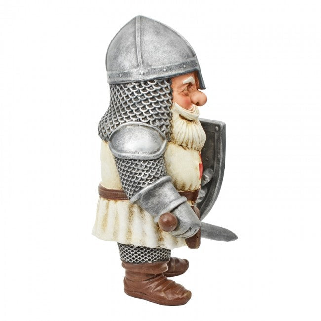 A small medieval knight figurine with a silver chainmail helmet, silver breastplate, white tunic, brown boots, and a shield, shown against a plain white background.