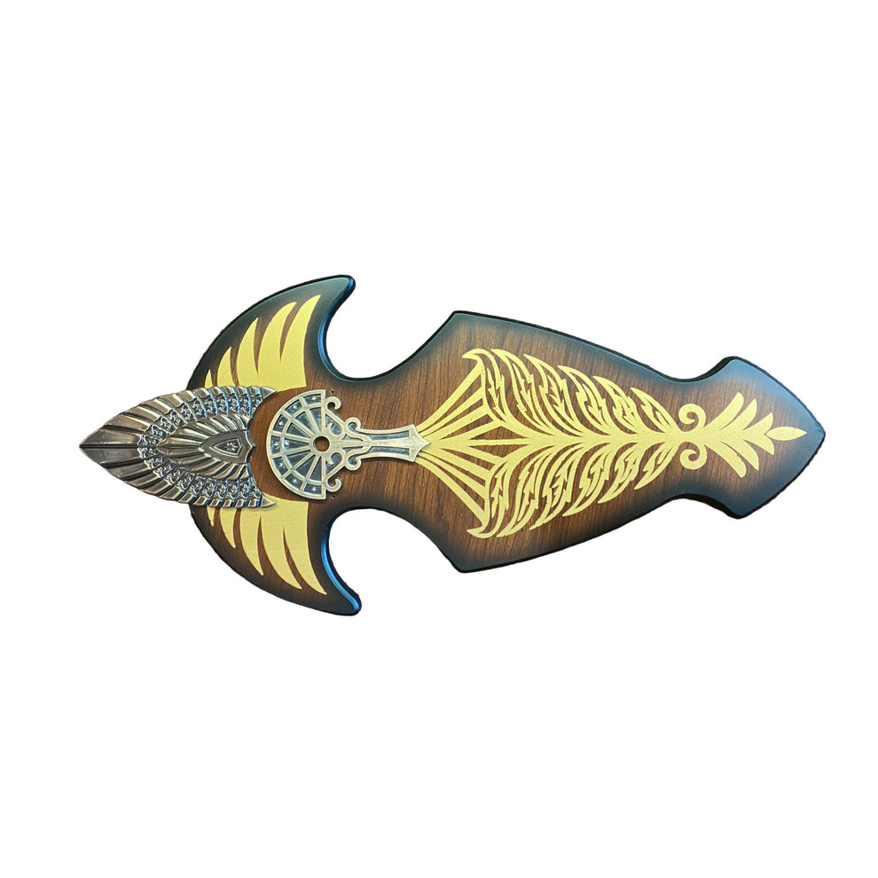 Decorative weapon with gold and silver designs on a brown textured background