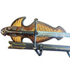 Decorative sword with ornate handle and sheath on a textured surface