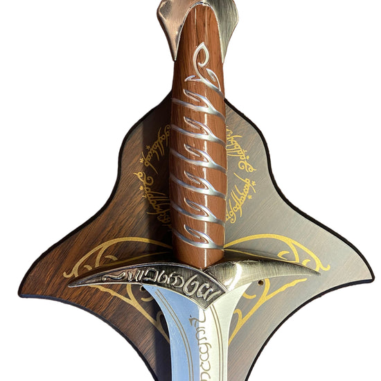 Decorative sword with wooden handle and silver blade on a textured brown background
