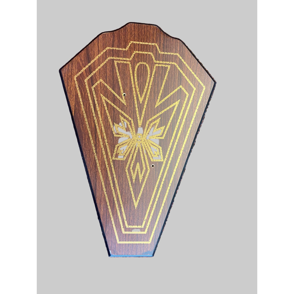 Wooden plaque with geometric design on a textured surface